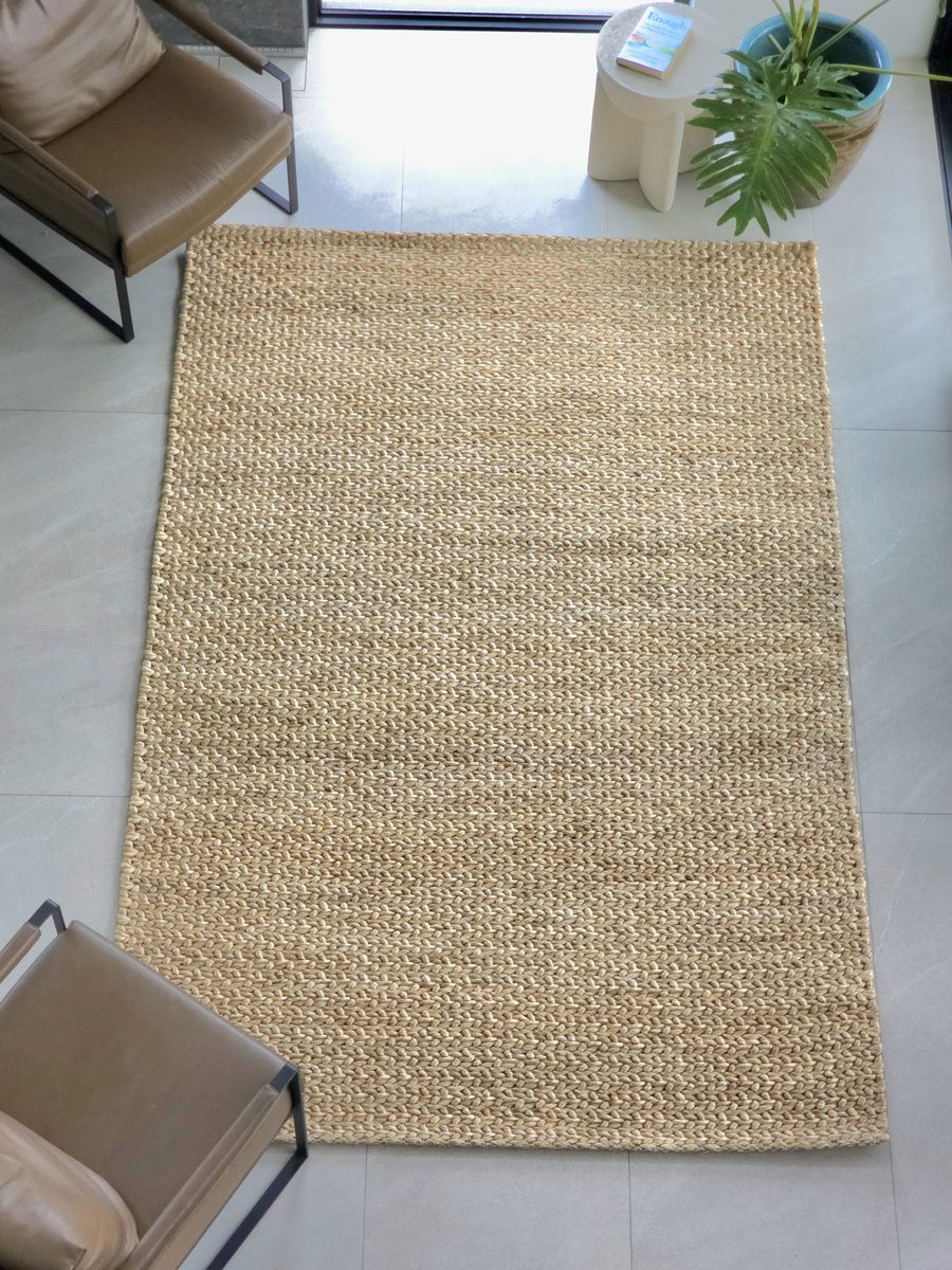 Chunky-weave abaca rug in a sitting area with two armchairs